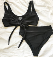 Flat image of versatile bikini top and high-waisted bikini bottoms, both in black.